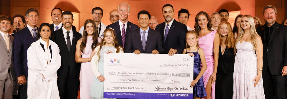 helping kids fight cancer foundation showing their big check from hyundai hope on wheels - McCarthy Hyundai of Topeka in Topeka KS